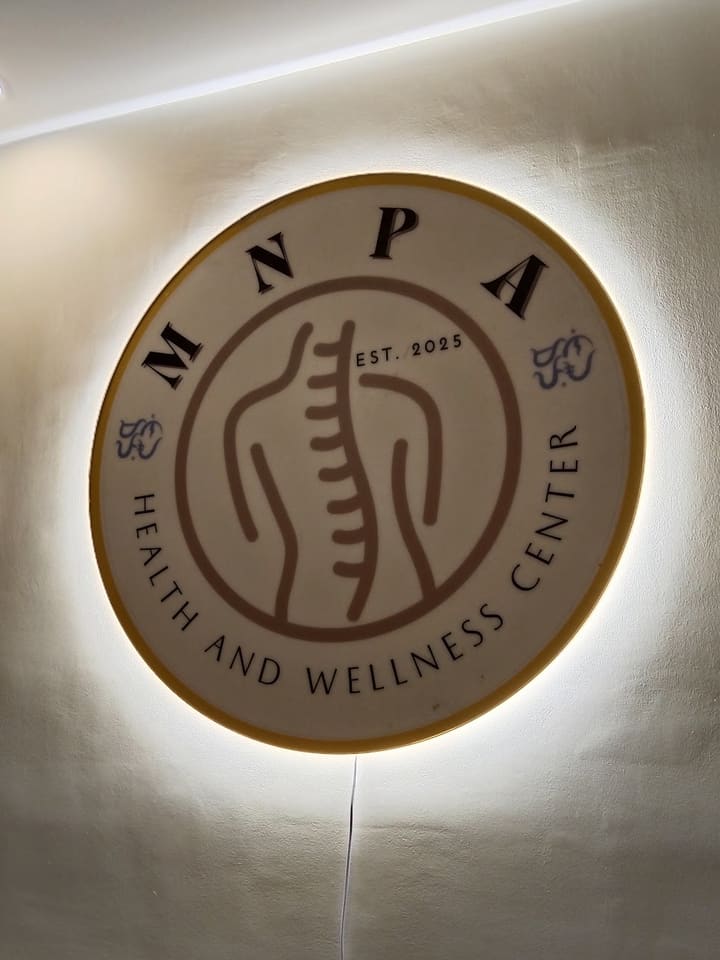 The backlit MNPA Health and Wellness Center sign inside the clinic
